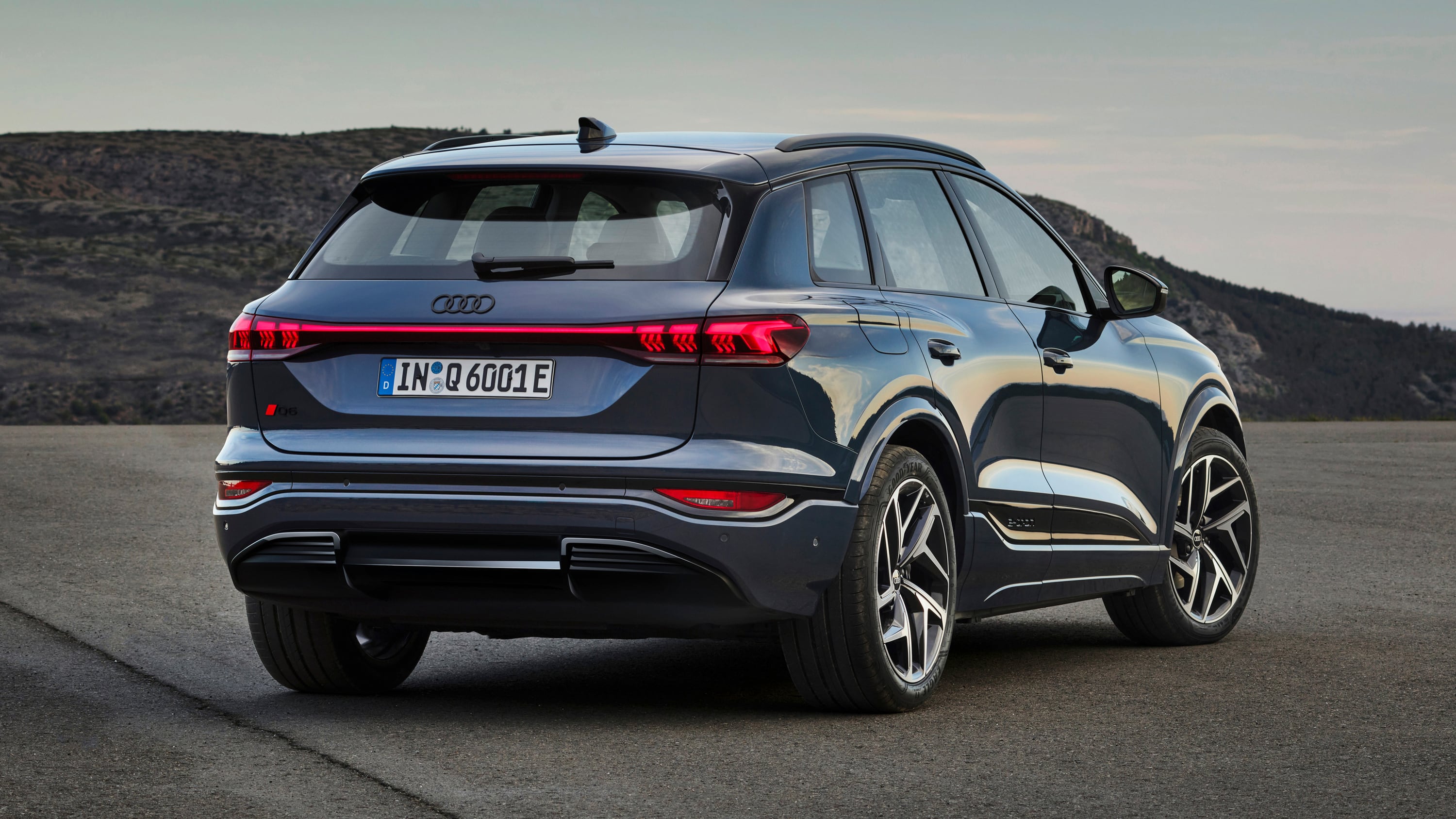 Audi Q6 E-tron Arc 2024 rear side view blue.jpg